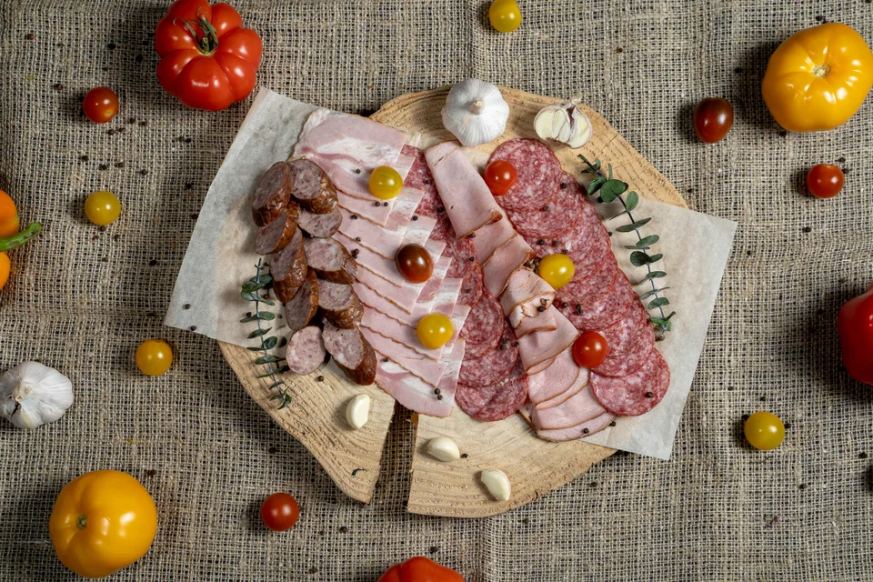 Example photo: Sliced cured meats and sausages on a wooden board